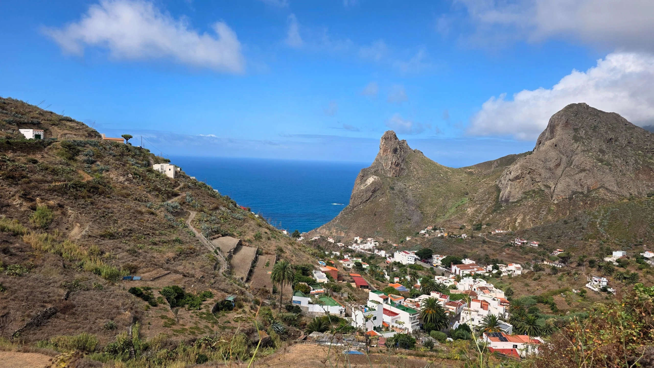 The white houses of Taganana below rock peaks, with the Atlantic beyond, in Anaga, Tenerife.